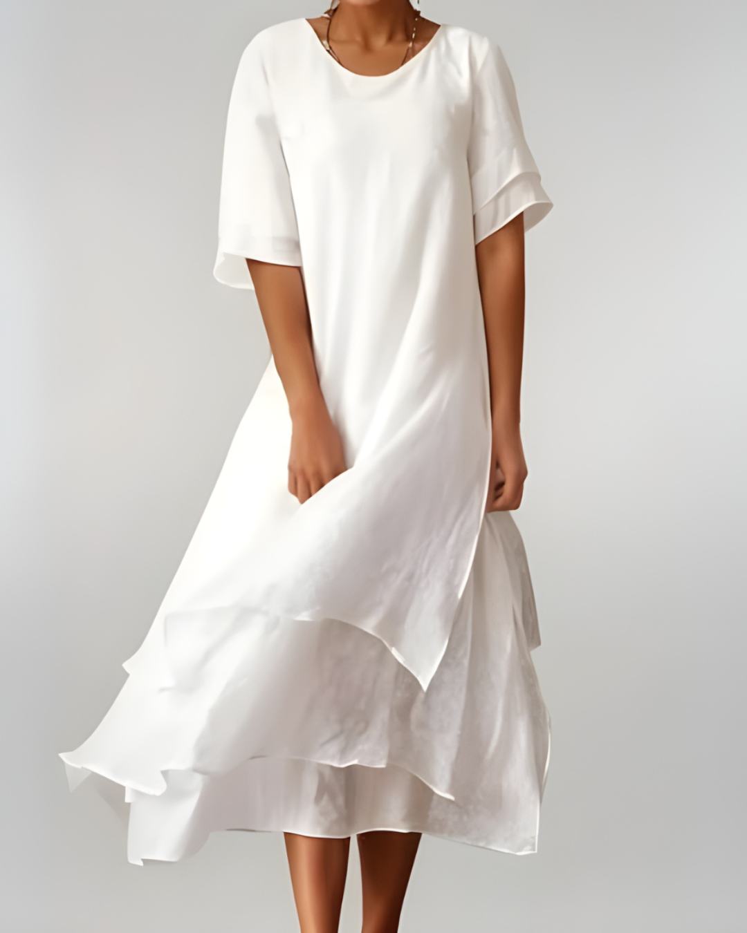 Woman wearing flowing maxi dress with open neckline