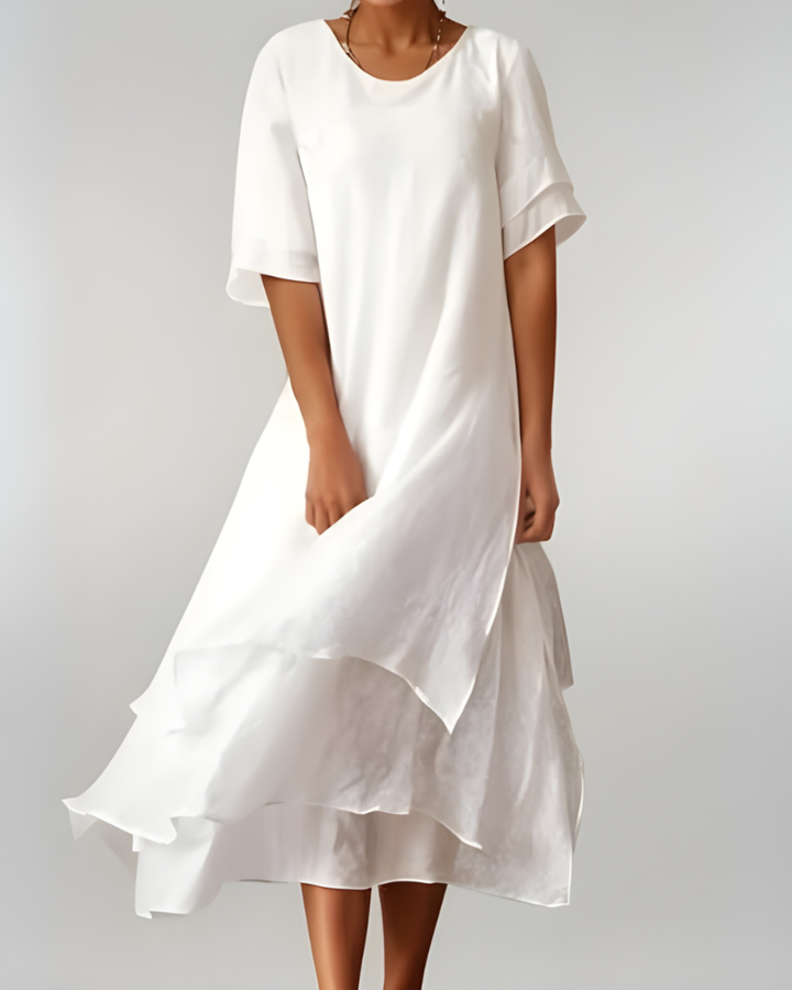 Woman wearing flowing maxi dress with open neckline