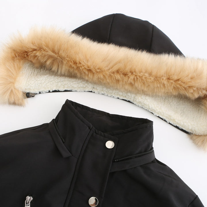 Woman wearing black hooded winter coat with faux wool collar