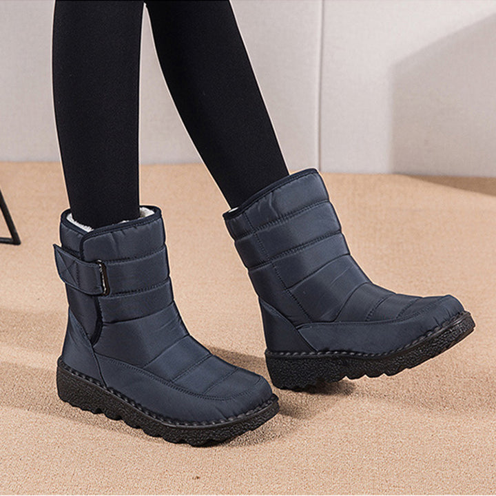 Woman wearing black plush-lined snow boots with buckle