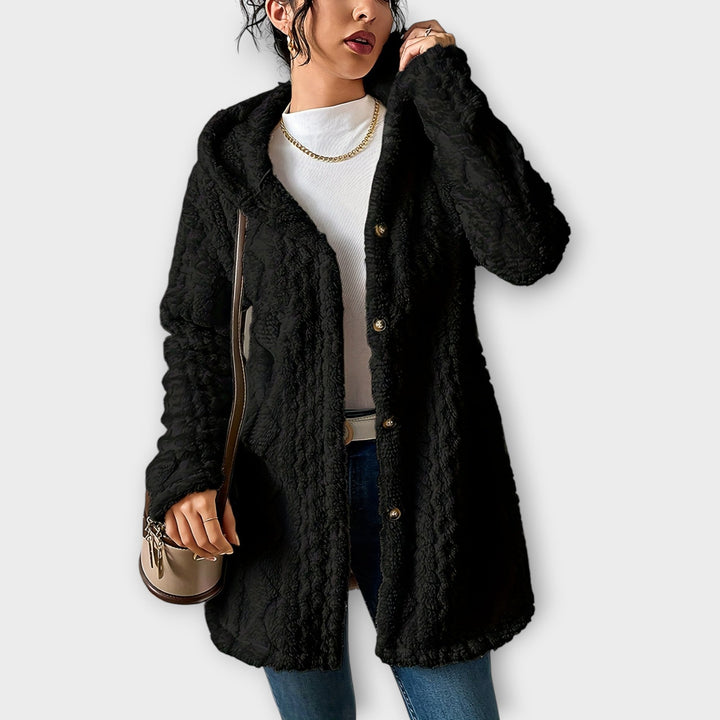 Woman wearing textured hooded winter jacket with relaxed fit