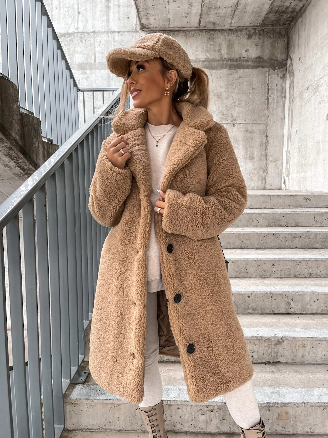 Woman wearing long lapel coat with fur collar