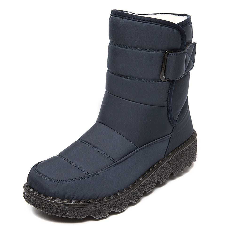 Woman wearing black plush-lined snow boots with buckle