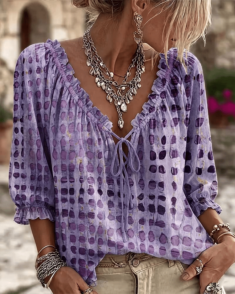 Woman wearing polka dot blouse with lace-up V-neck