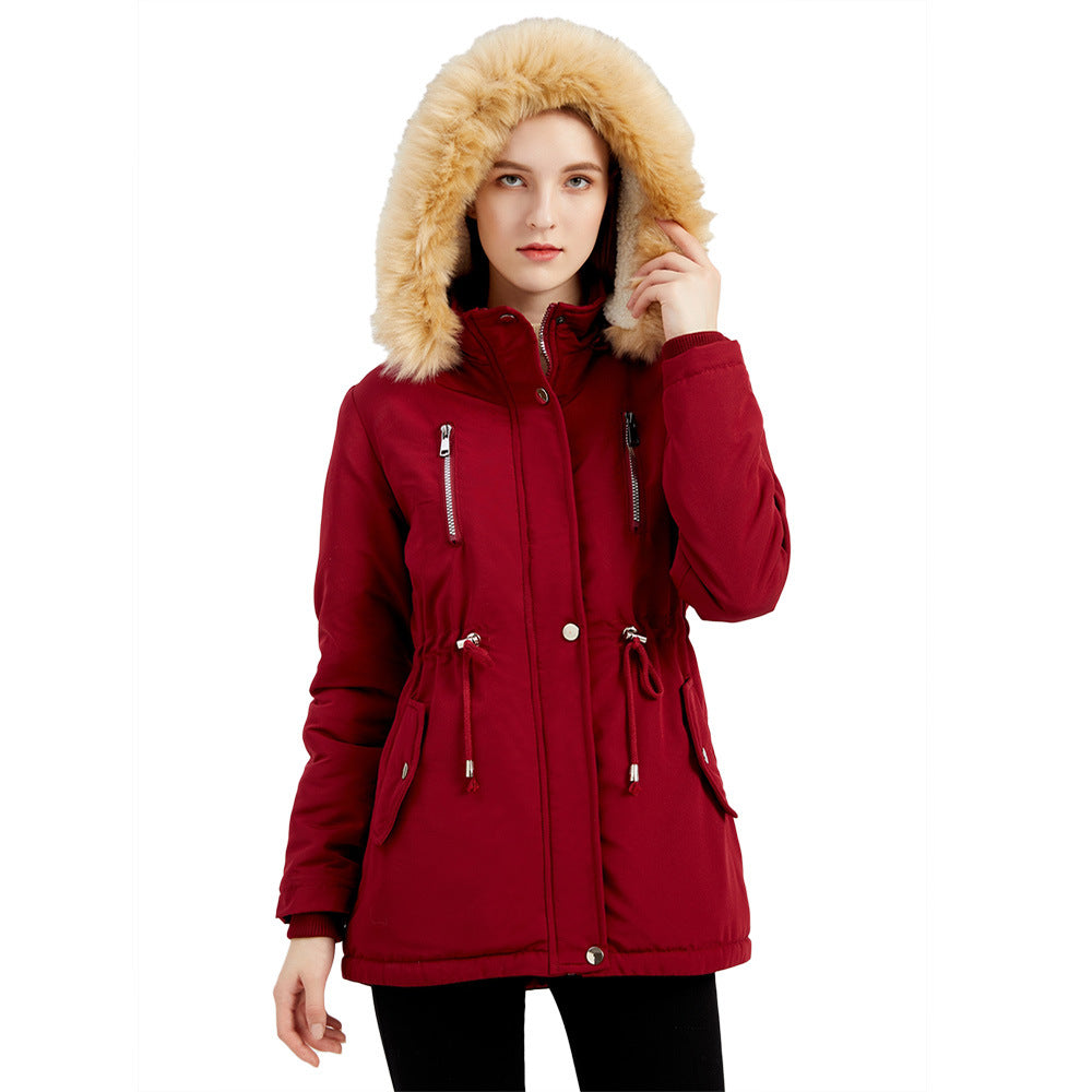 Woman wearing black hooded winter coat with faux wool collar