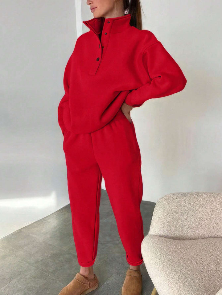Woman wearing oversized snap collar pullover and sweatpants set – red