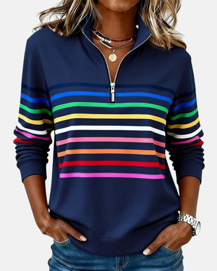 Woman wearing rainbow striped zip sweatshirt with stand collar
