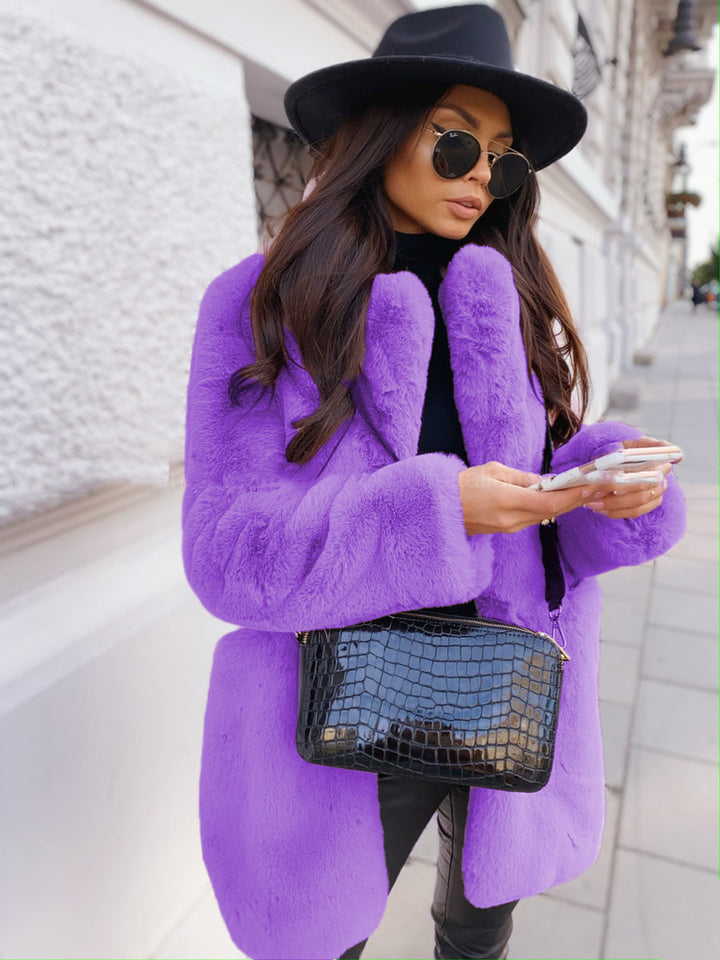 Woman wearing long faux fur coat with lapel collar