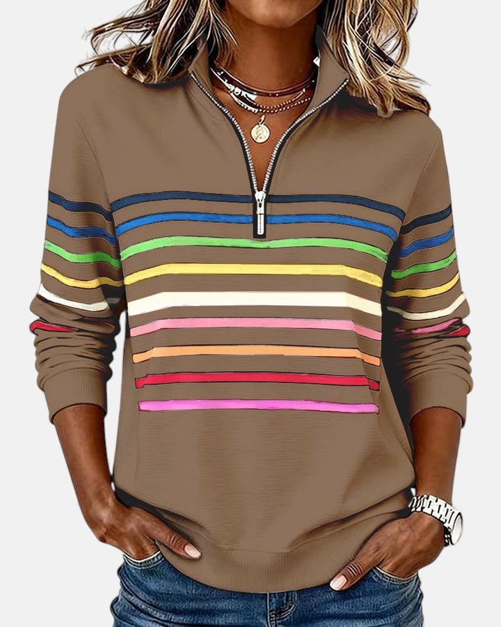 Woman wearing rainbow striped zip sweatshirt with stand collar