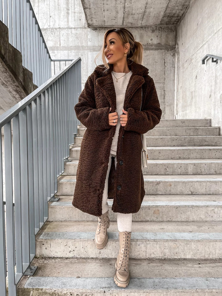 Woman wearing long lapel coat with fur collar