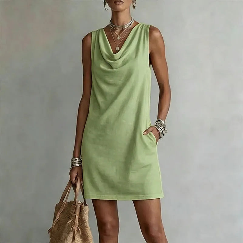 Woman wearing sleeveless mini dress with draped neckline