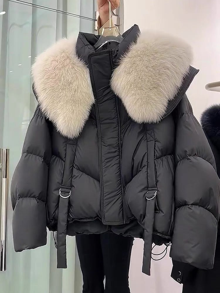 Woman wearing black padded winter coat with fur collar