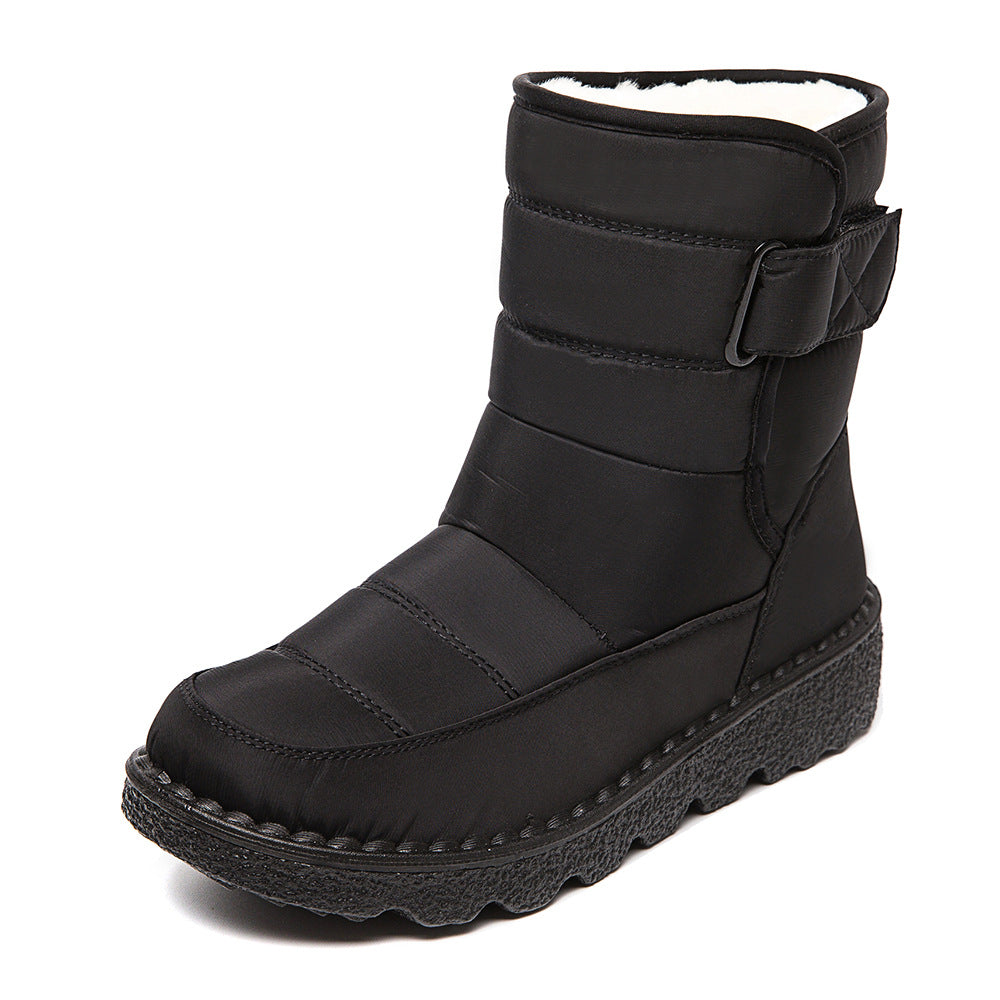 Woman wearing black plush-lined snow boots with buckle