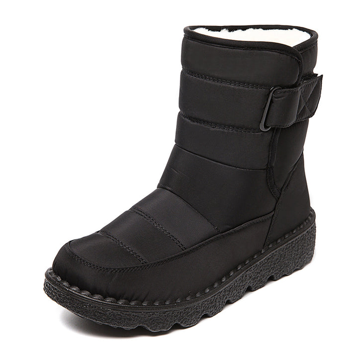 Woman wearing black plush-lined snow boots with buckle