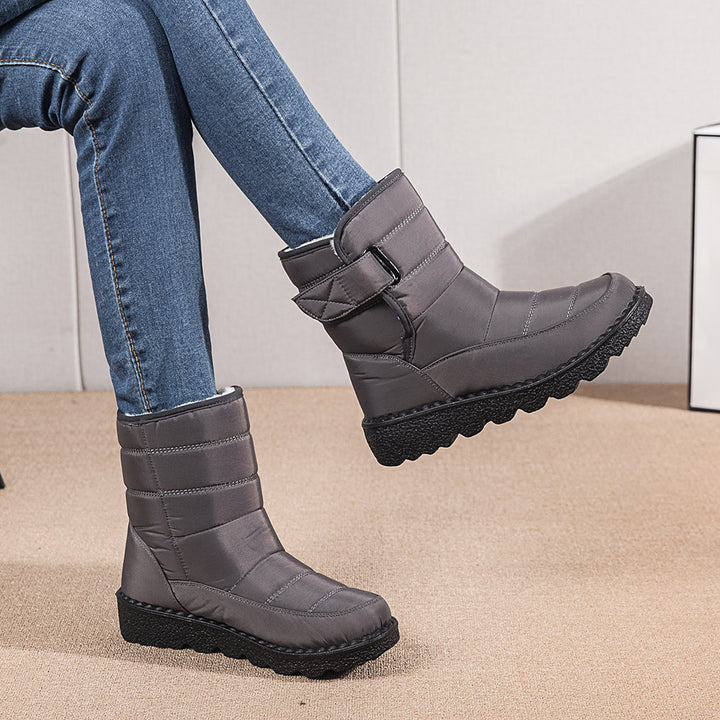 Woman wearing black plush-lined snow boots with buckle