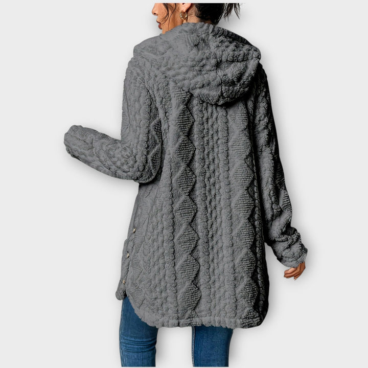 Woman wearing textured hooded winter jacket with relaxed fit