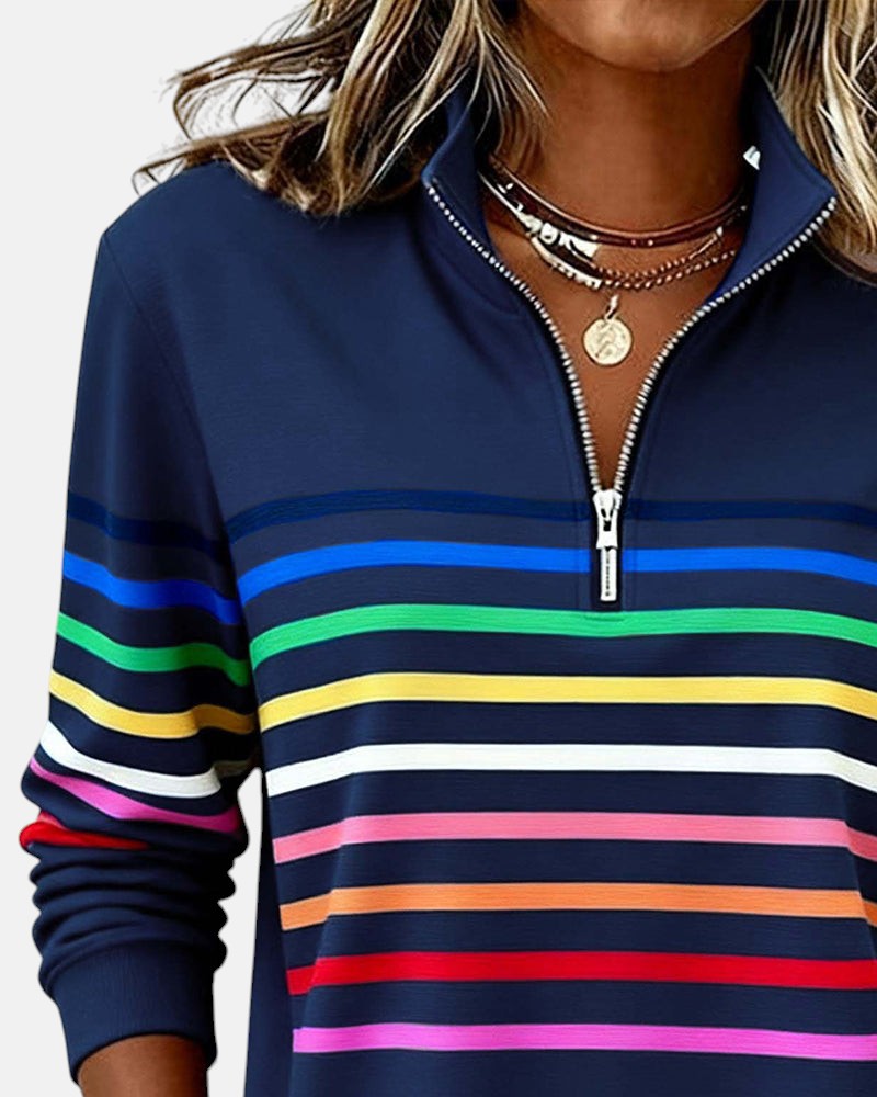 Woman wearing rainbow striped zip sweatshirt with stand collar