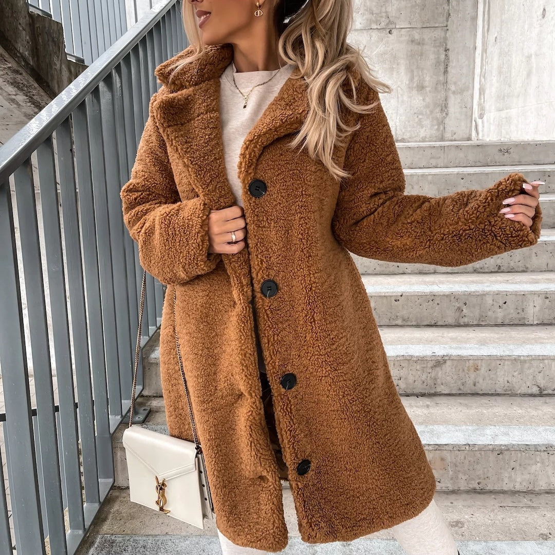Woman wearing long lapel coat with fur collar