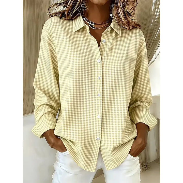 Woman wearing gingham button-up blouse with long sleeves