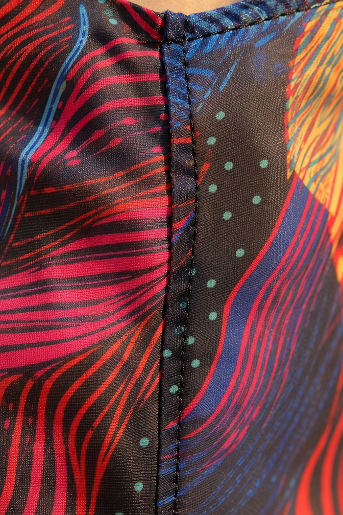 Woman wearing multicolor crystal maxi dress with sheer mesh overlay