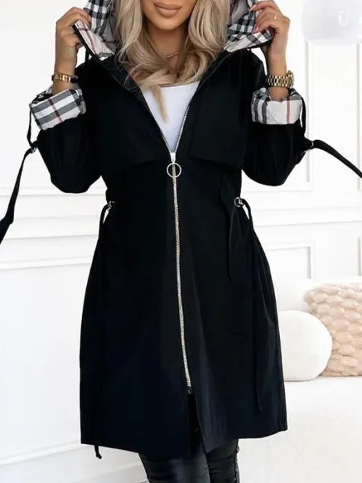 Woman wearing long coat with checked hood